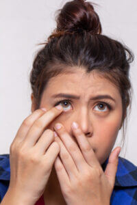 Woman putting in contact lens