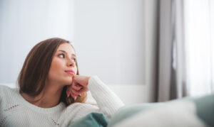 Woman looking outside of window