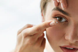 Woman putting in contact